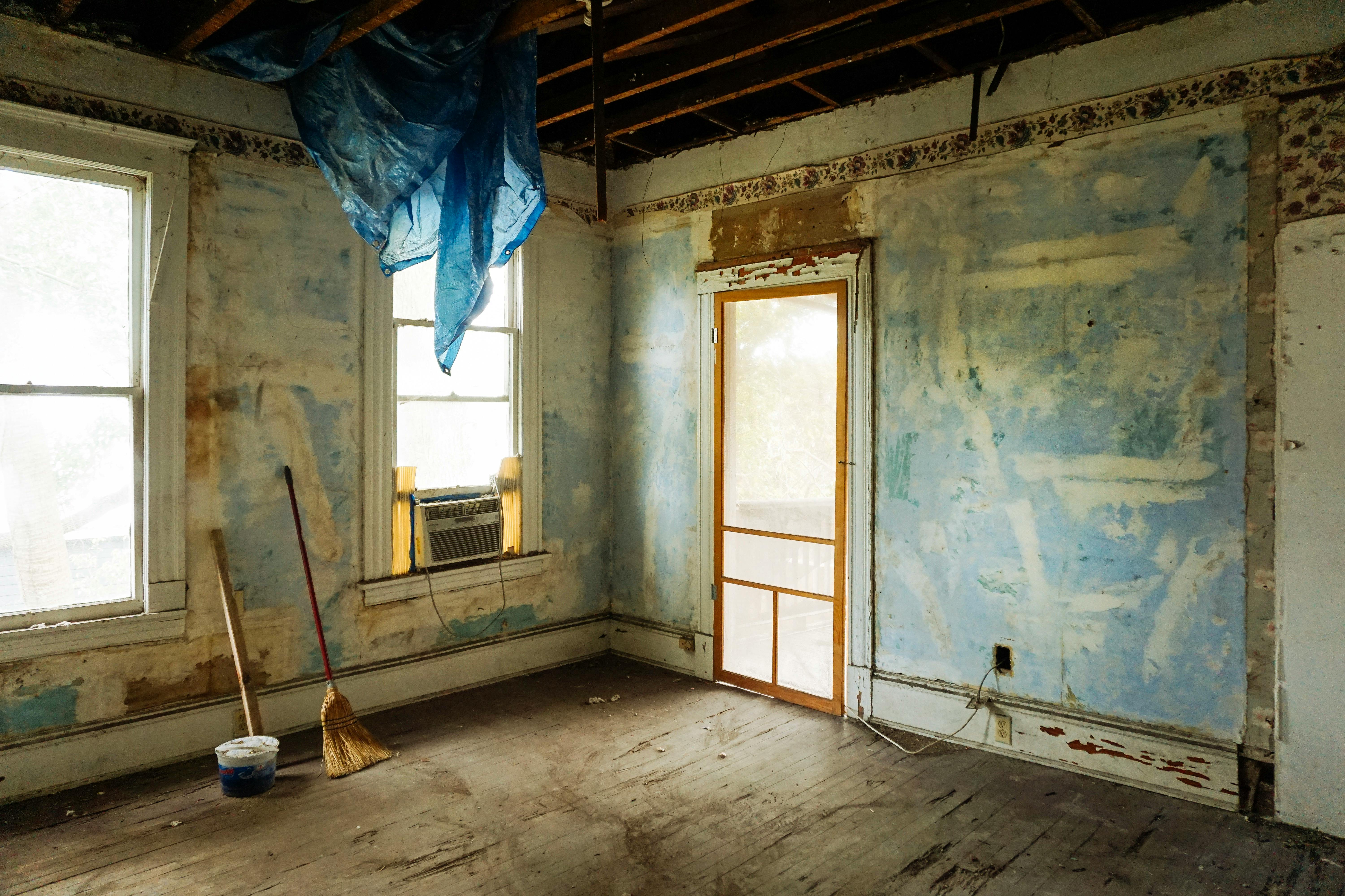 Old Yorkshire home mid-renovation, highlighting pre-refurbishment stage with exposed ceilings and stripped wallpaper.