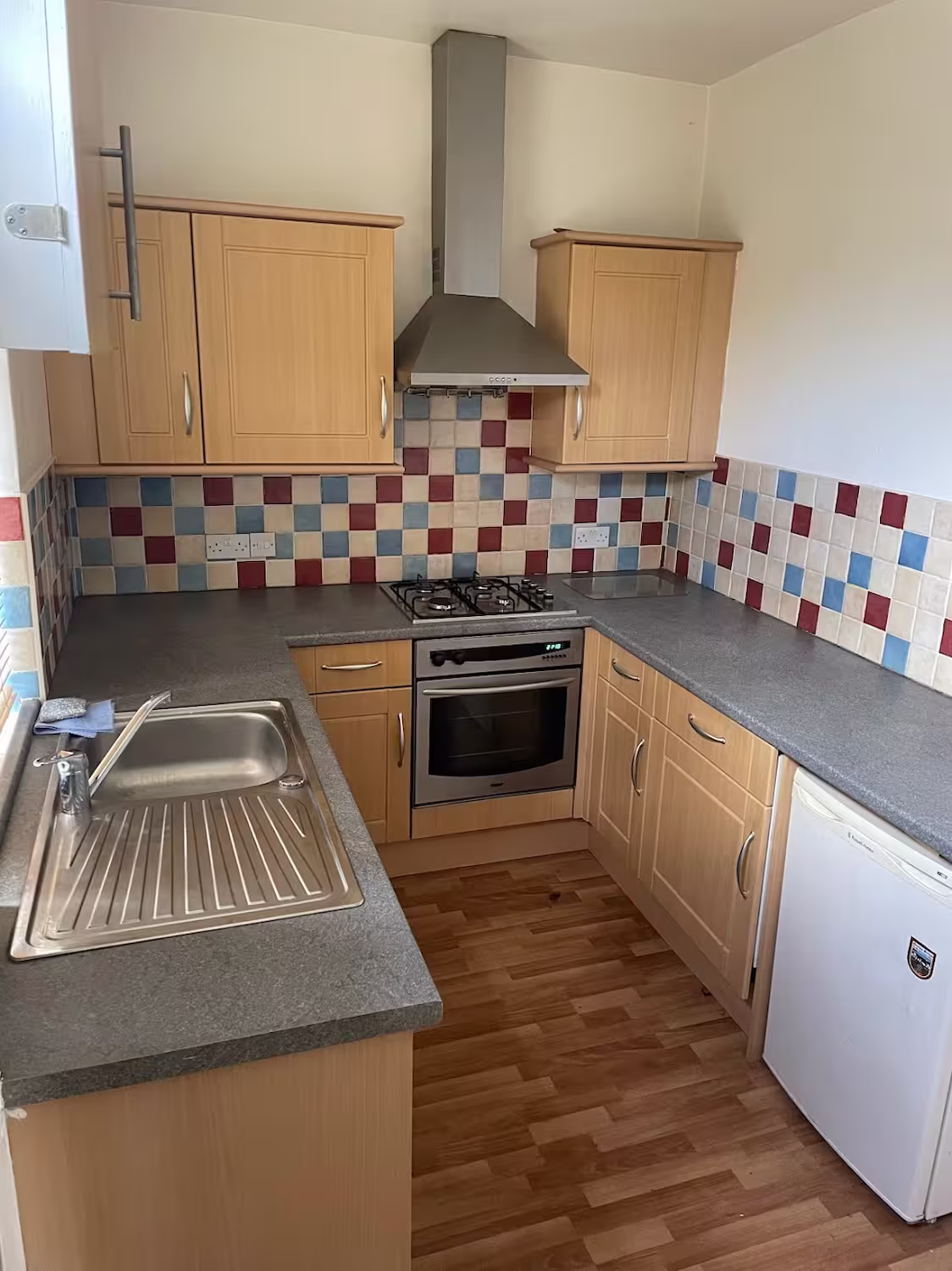 Old and outdated UK kitchen before renovation, showing the type of property overseas investors often refurbish for added value.