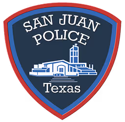 The Logo for the San Juan Texas Police Department. Features white text against a dark blue background that reads "SAN JUAN POLICE, TEXAS" and a graphic of the Basilica in the center.
