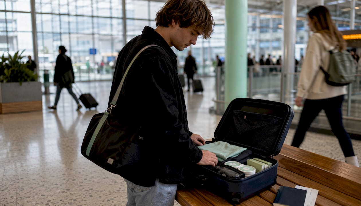 Traveler packing nicotine pouches in suitcase at airport