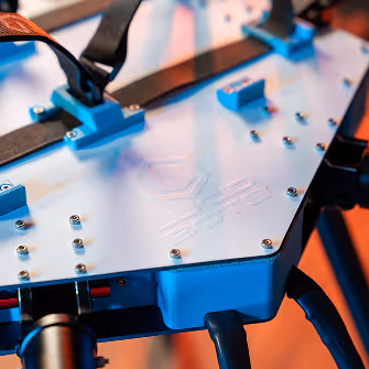 Close-up of a white mechanical device with blue accents and "Lucid Bots" logo. Features bolts and straps, exuding a sleek, futuristic design.