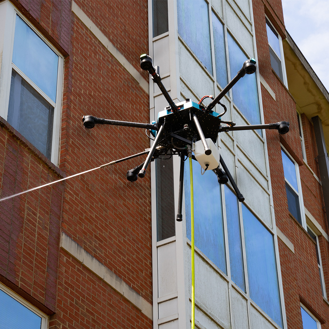 Lucid Bots Sherpa drone cleaning commercial building exterior