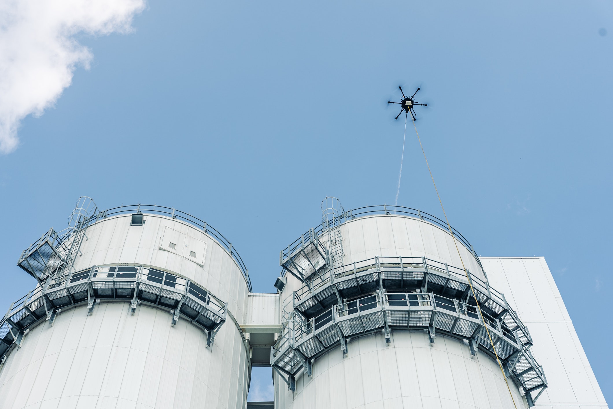 Sherpa pressure washing drone in operation on building exterior