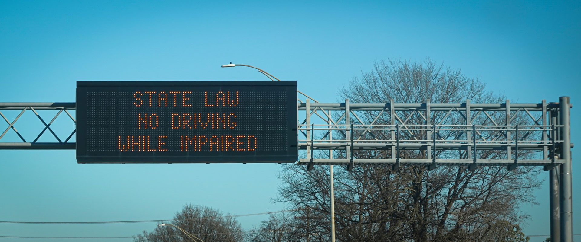 highway billboard stating "no driving while impaired"