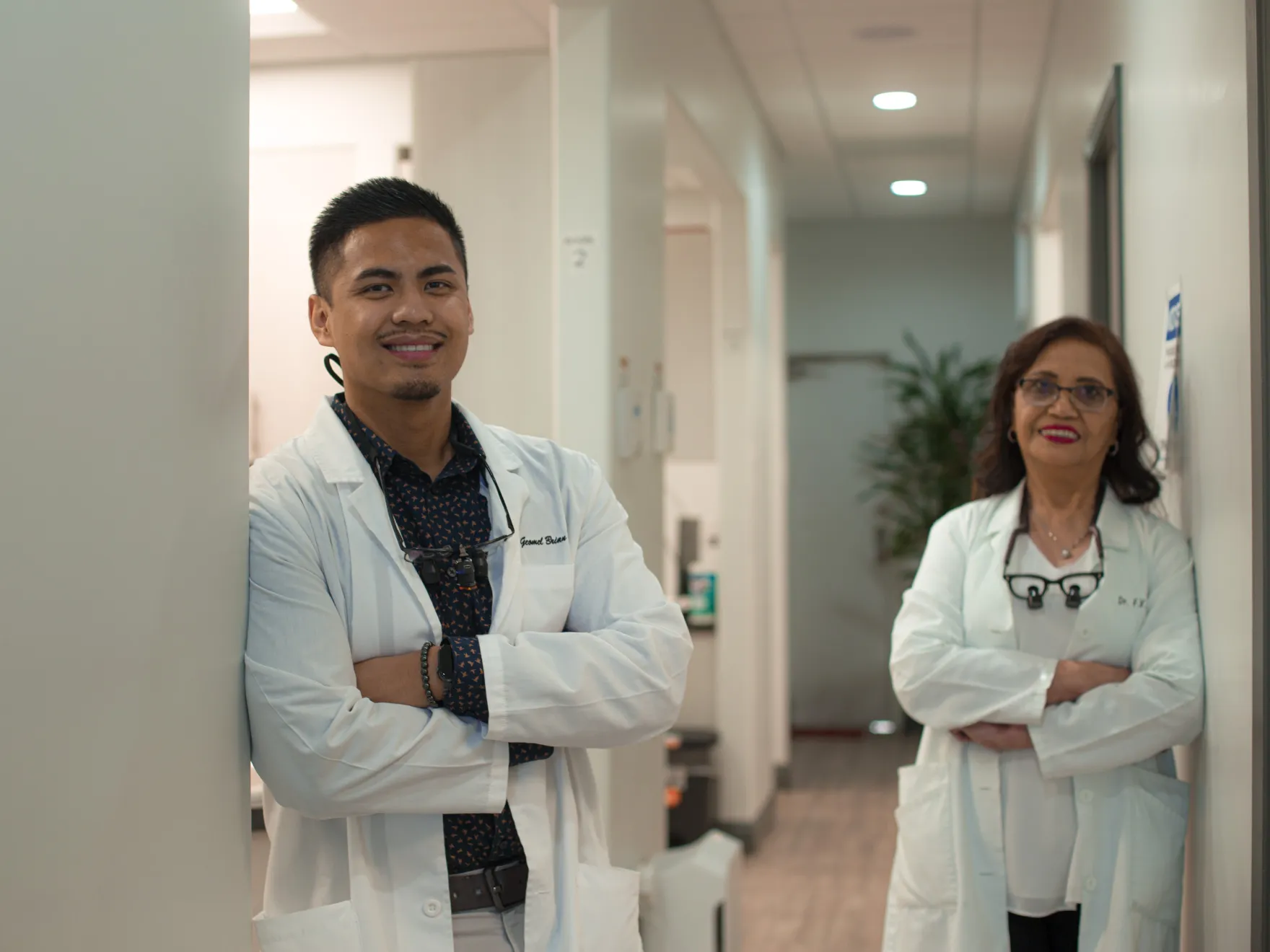 there are two doctors standing in a hallway with their arms crossed Dynamic Dental