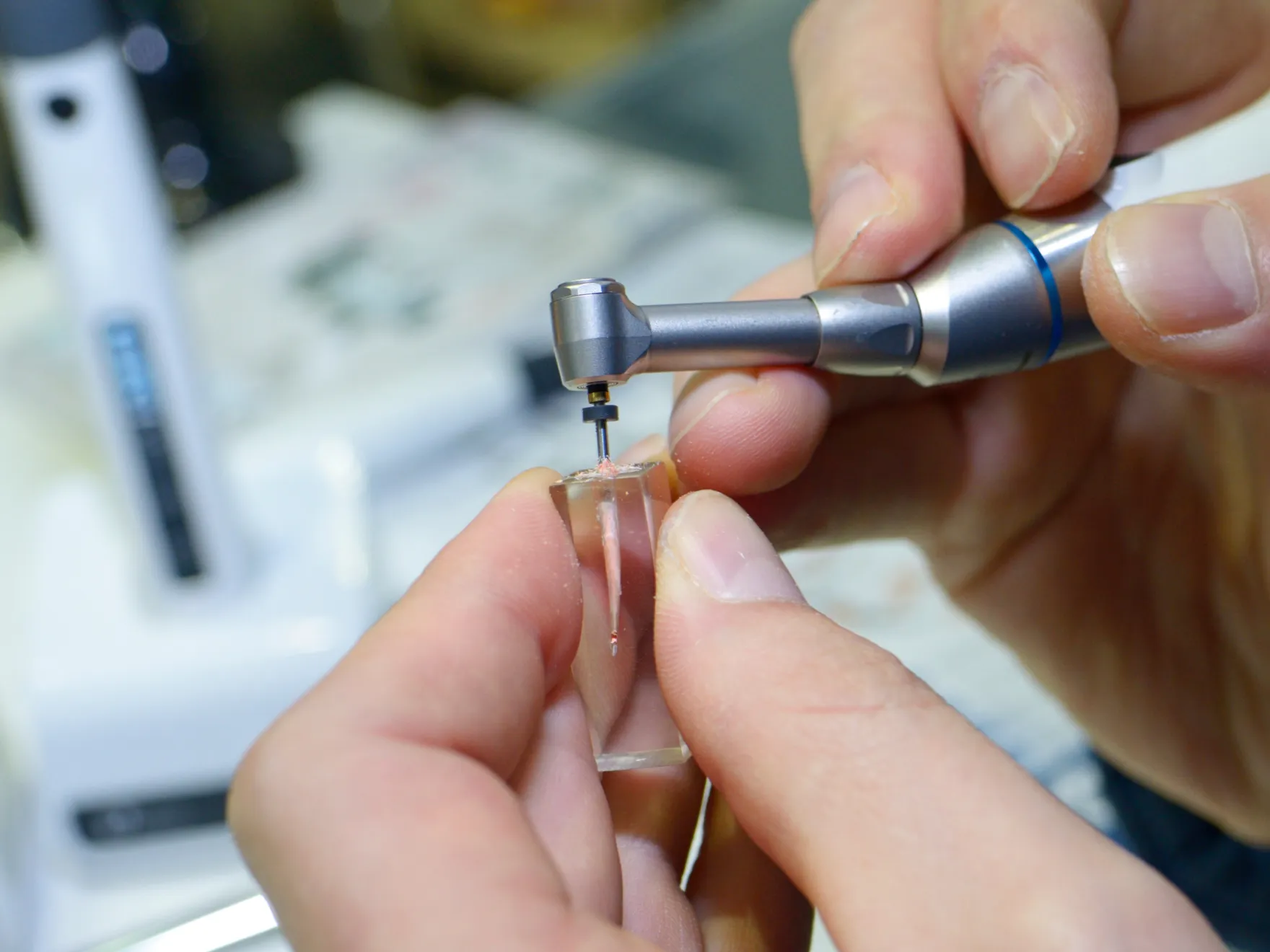 someone is using a dental device to fix a toothbrush  Dynamic Dental