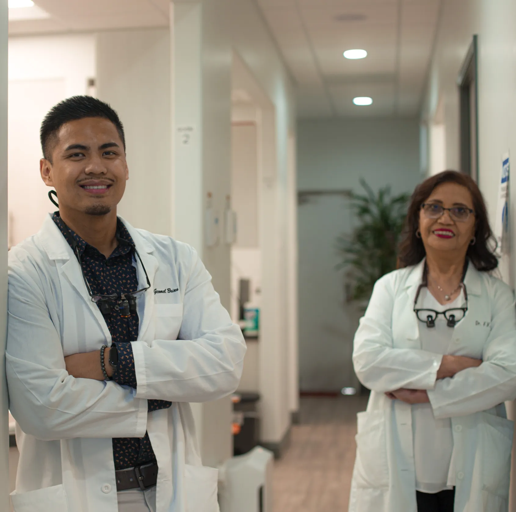 there are two doctors standing in a hallway with their arms crossed  Dynamic Dental