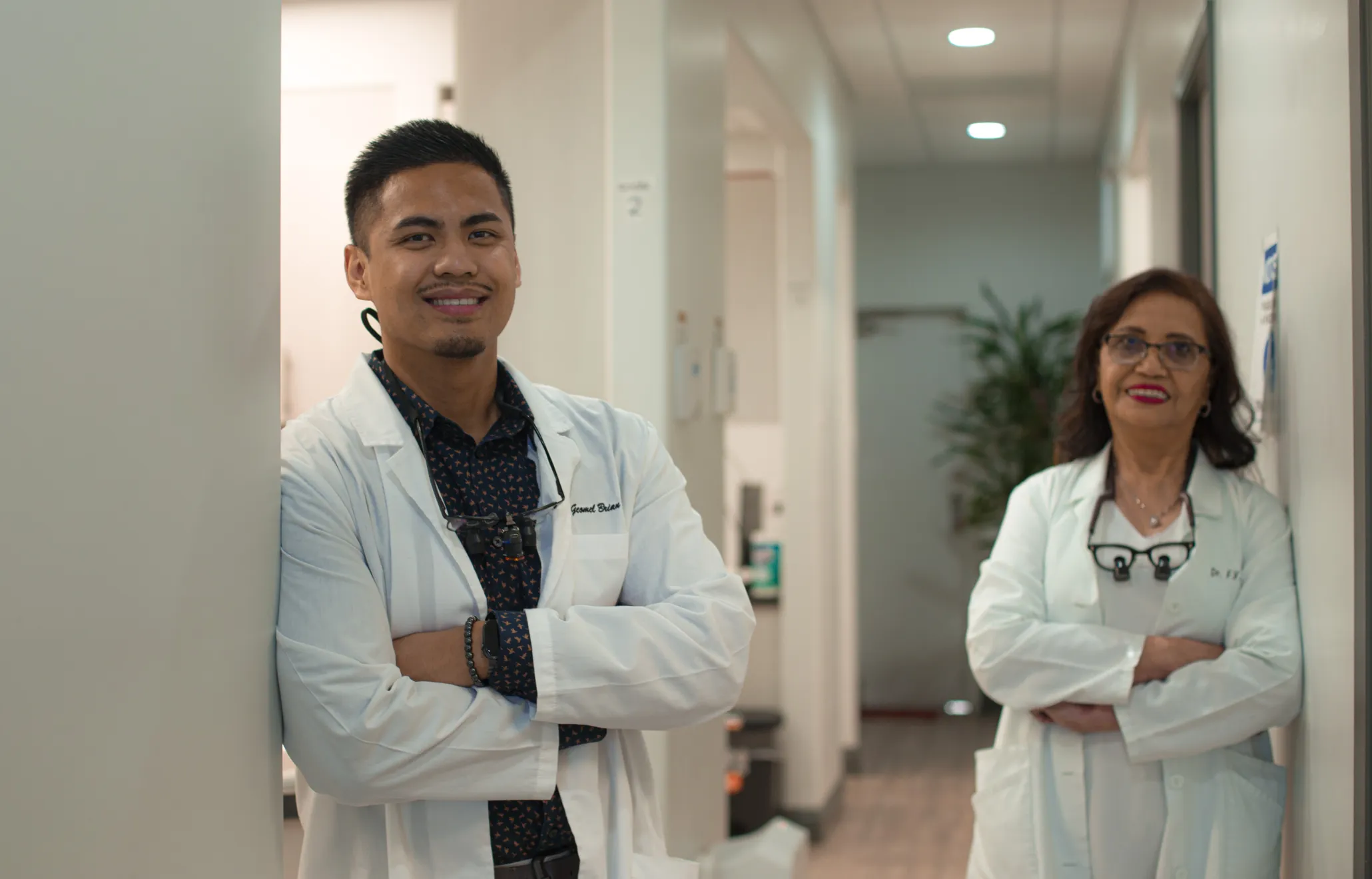 there are two doctors standing in a hallway with their arms crossed  Dynamic Dental