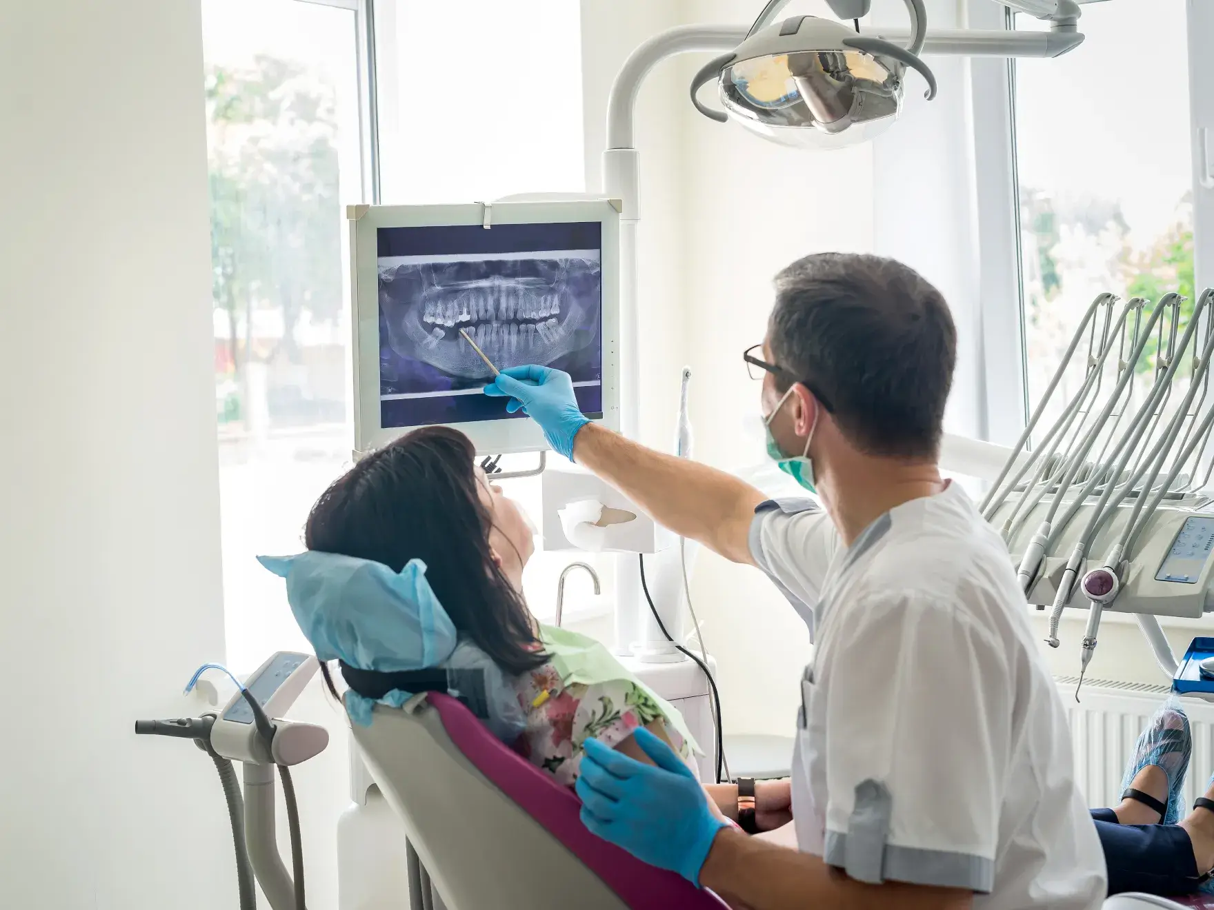 patient in a dental office with a dentist examining a patient's teeth Dynamic Dental