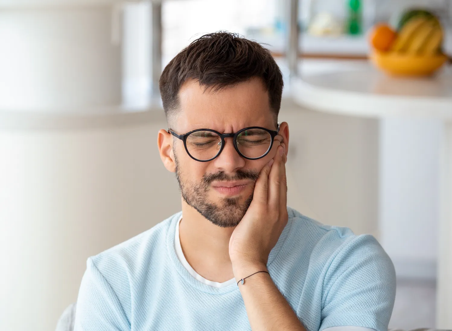 there is a man with glasses sitting at a table with a plate of food Dynamic Dental