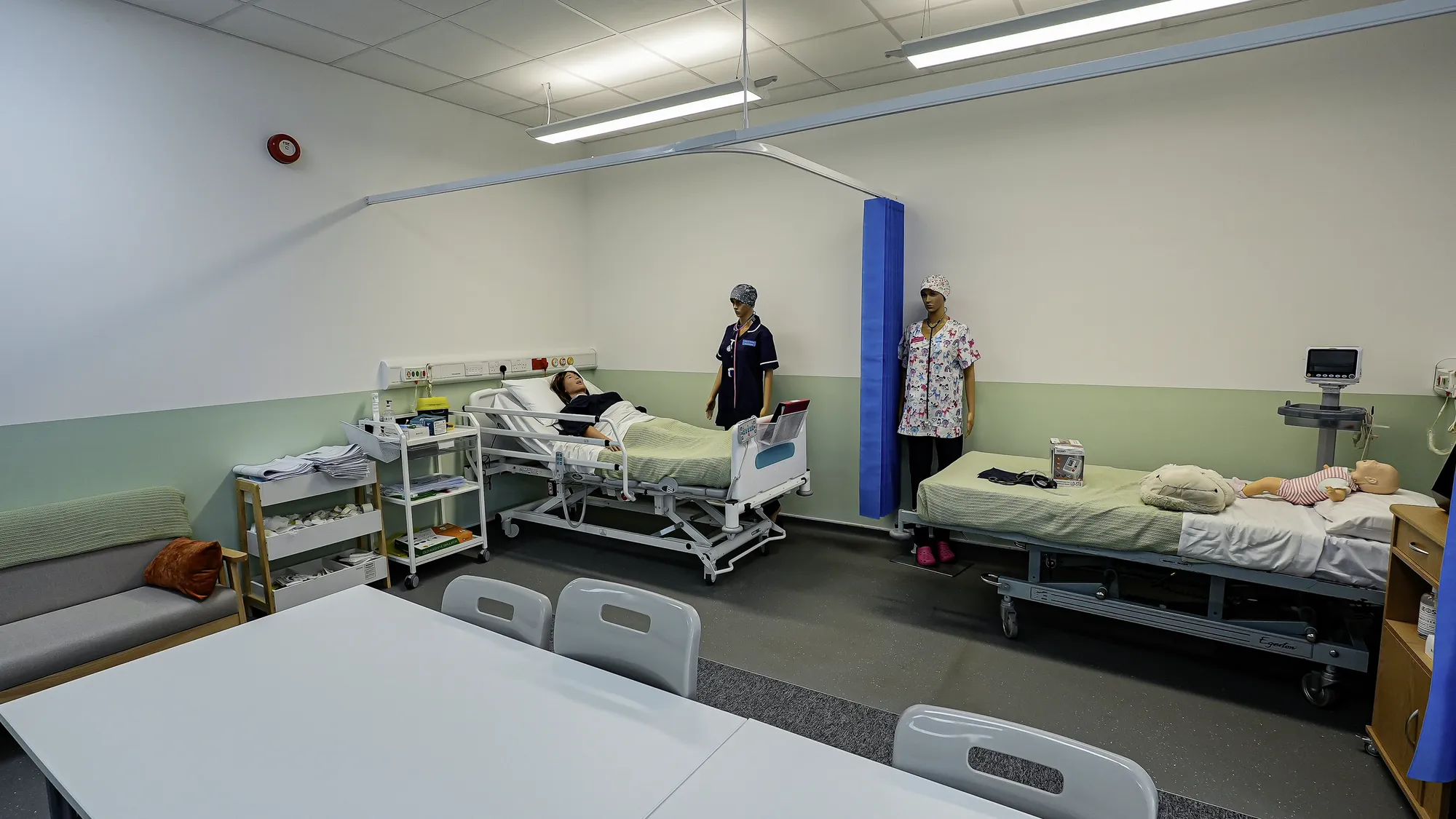 Simulated hospital ward with training beds and manikins