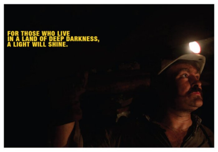 A miner in the last deep-cast coal mine in Hungary set to close. Over the top left corner of the photo are the words of Isaiah9:2, 'For those who live in a land of deep darkness, a light will shine.' Source: REUTERS/Laszlo Balogh
