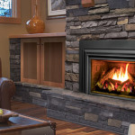 Enviro Cleanface Large Fireplace Insert E33 installed in a stone fireplace, featuring a clean face design, vibrant flames, and a cozy living room setting.