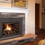 Enviro Cleanface Medium Fireplace Insert E30 installed in a modern living room, featuring a clean face design, realistic log set, and flames, surrounded by a stone mantel and wooden flooring.