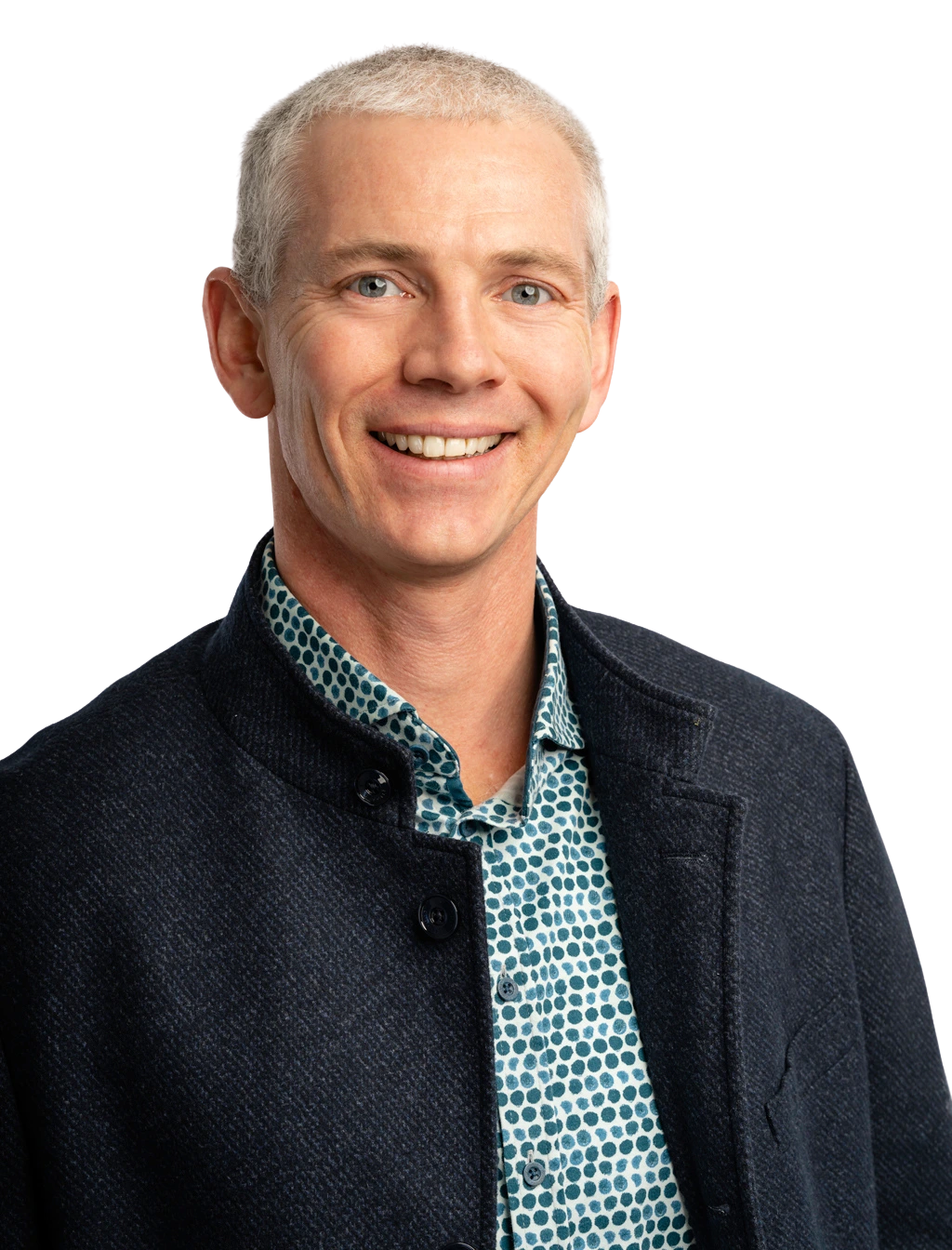 Professional headshot of a team member wearing business attire, smiling confidently against a plain white background.