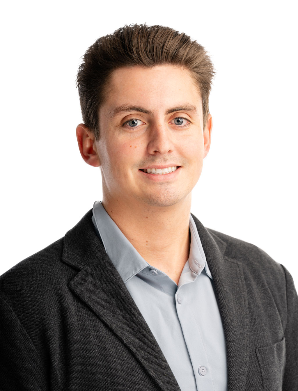 Professional headshot of a team member wearing business attire, smiling confidently against a plain white background.