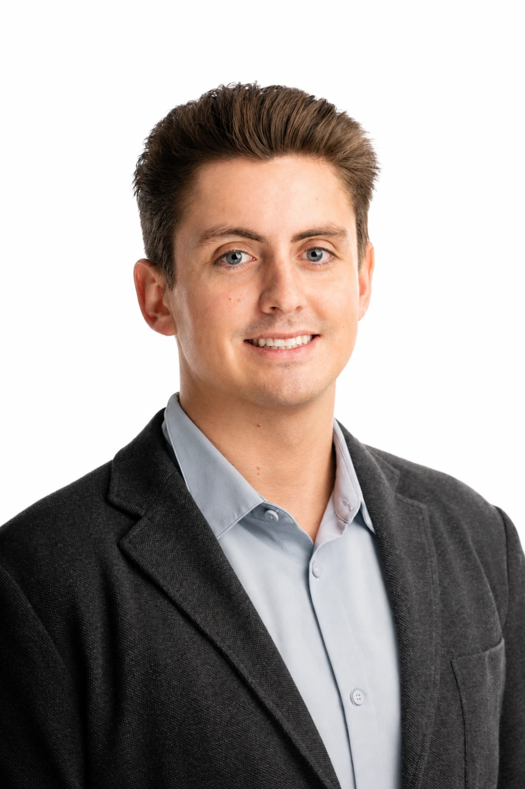 Professional headshot of a team member wearing business attire, smiling confidently against a plain white background.