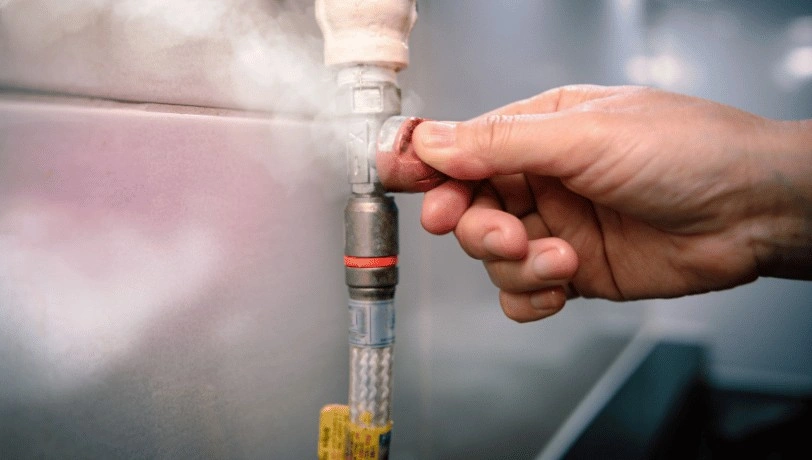 Hand turning valve on leaking pipe.