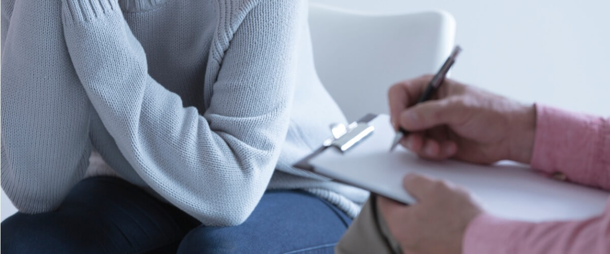 Girl in session with psychotherapist, discussing issues in a calm office setting.