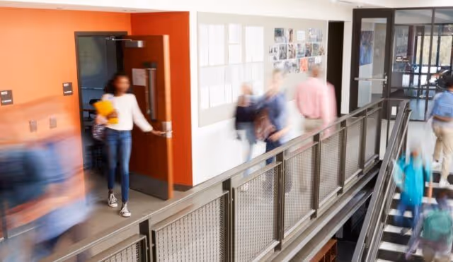 busy-high-school-corridor-during-recess-with-blurred-students-and-picture-id976317922-640x371