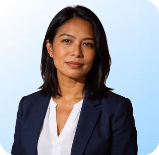 Confident woman with shoulder-length dark hair wearing a white blouse and navy blazer.