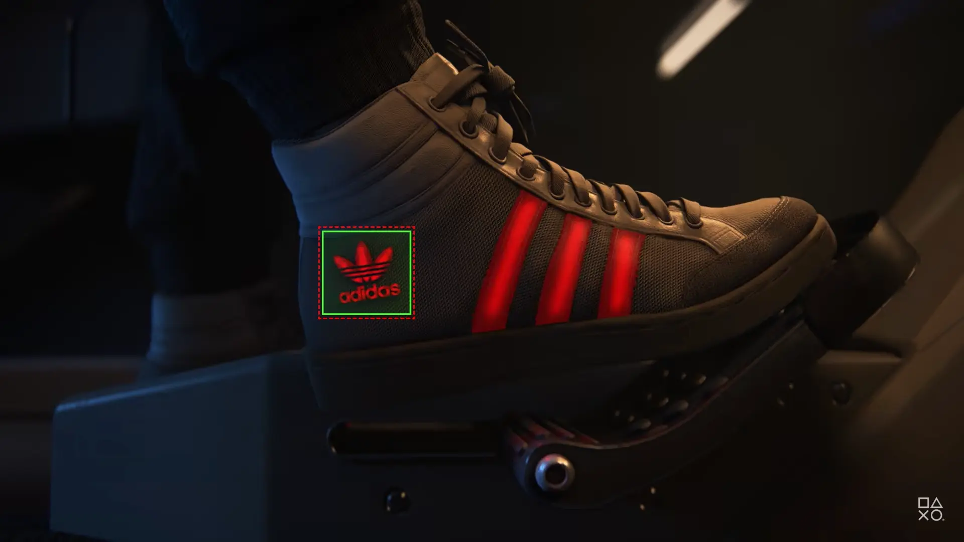 Detailed shot of a sneaker pressing on a pedal, featuring glowing red stripes and the Adidas logo on the shoe.