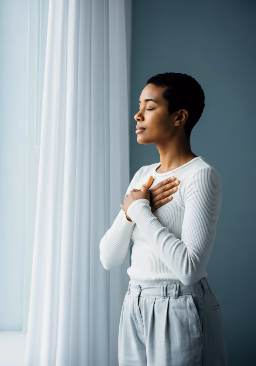 Woman with hands over heart during EMDR therapy session. Serving women/femmes of color, queer & trans people, and BIPOC communities in San Diego, California.