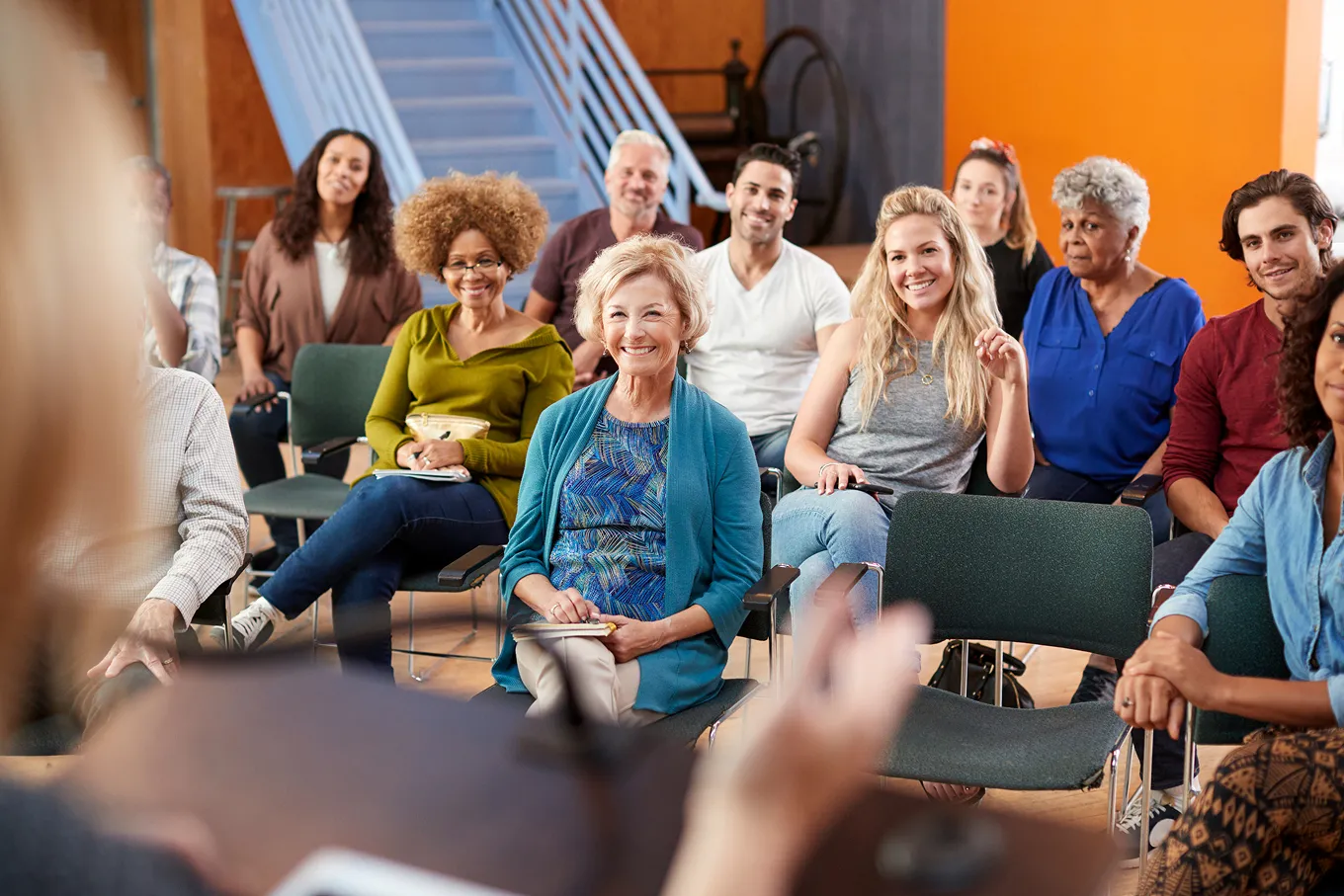 woman giving presentation to a middle-aged and elderly audience
