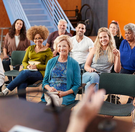 woman giving presentation to a middle-aged and elderly audience