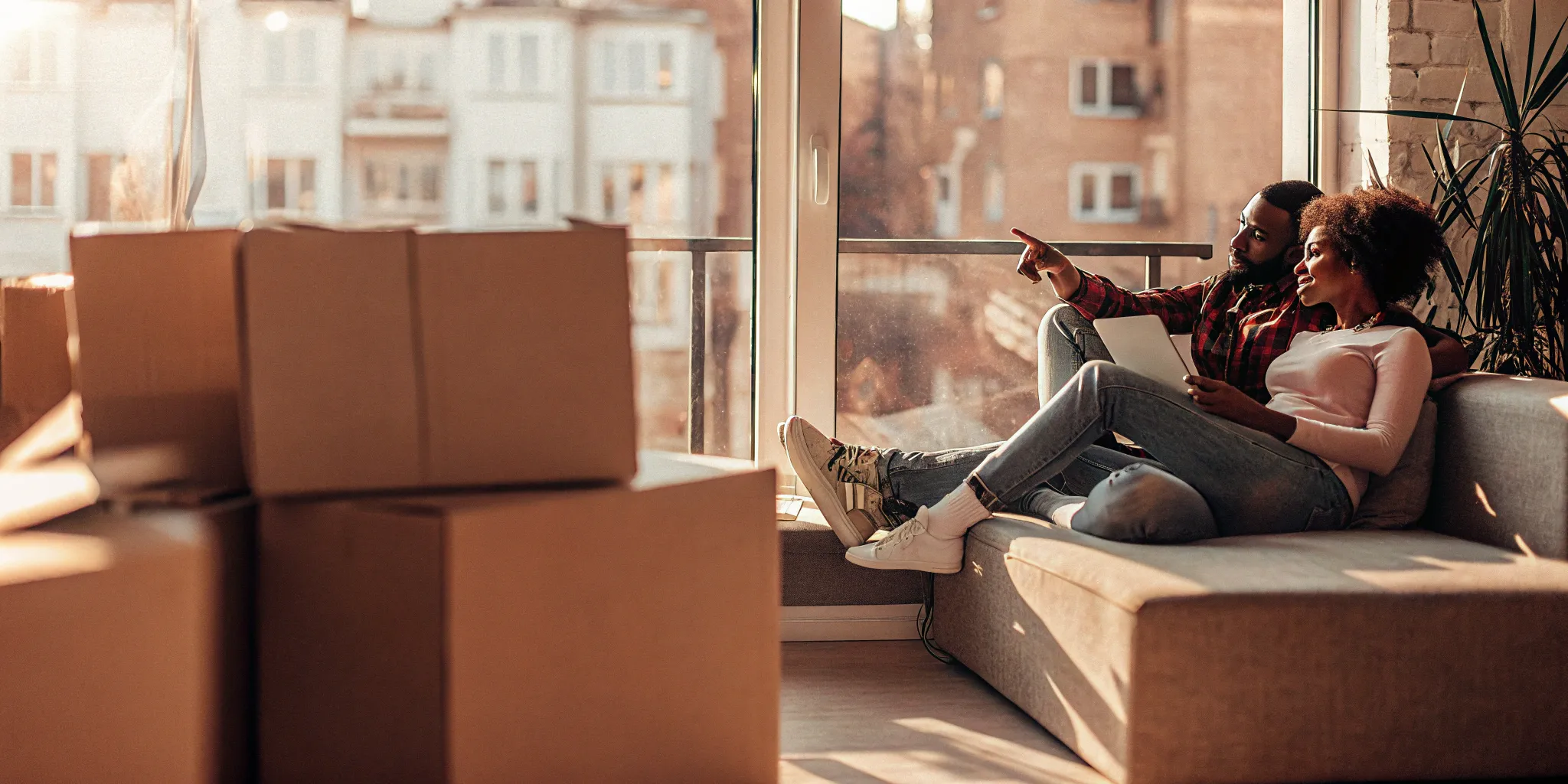 Last-minute movers packing with checklist on tablet.