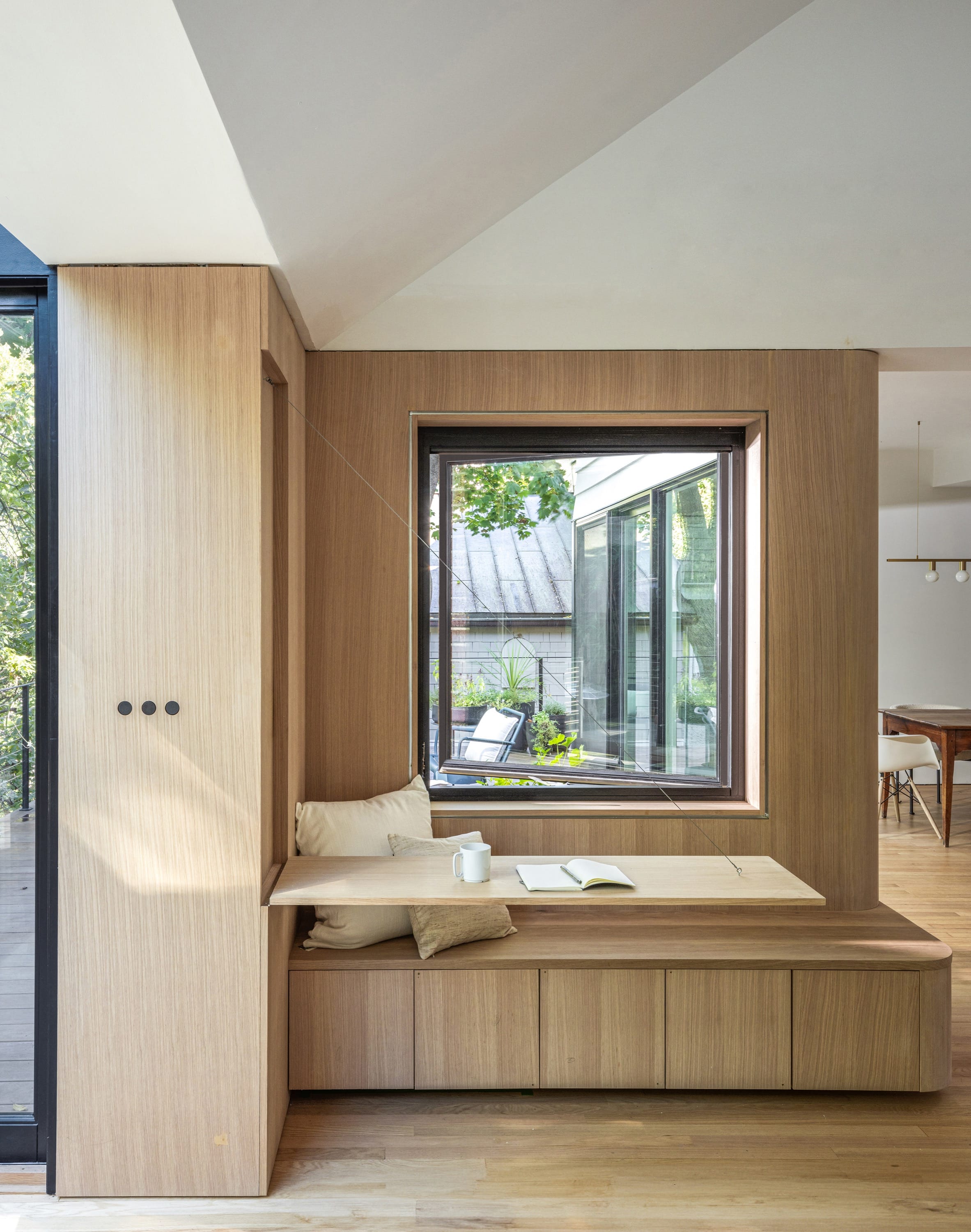 Window seat with wood paneling and natural light.