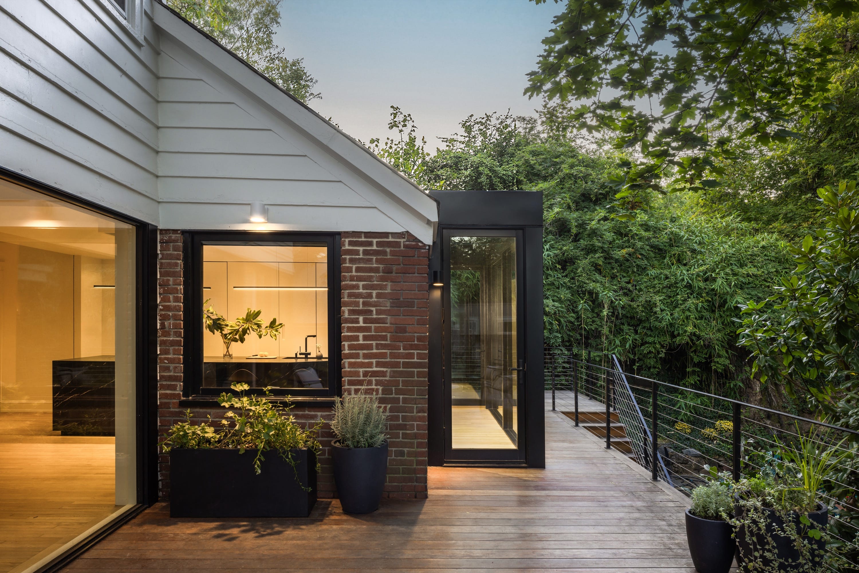 Exterior patio with glass walls and outdoor seating.