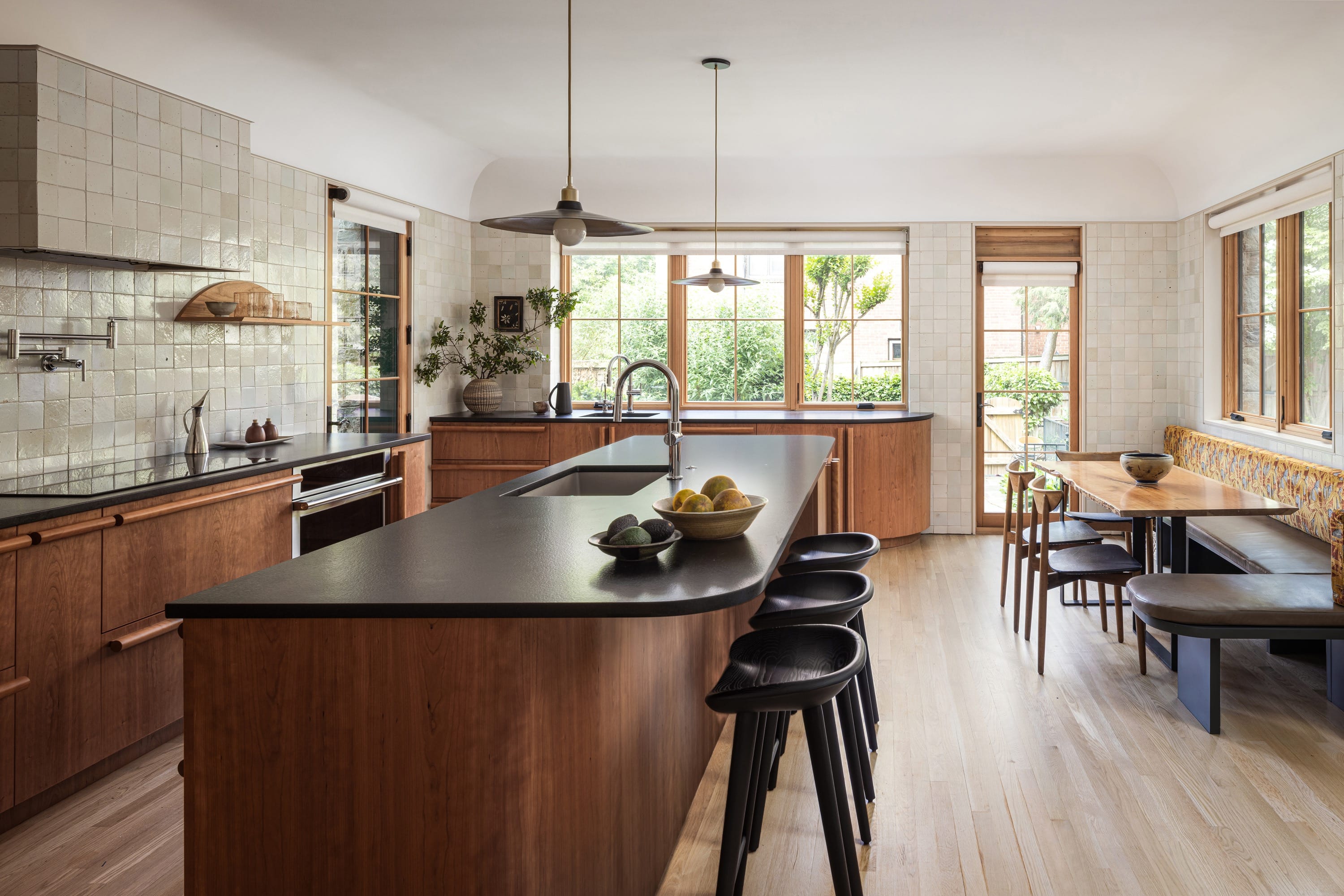 Kitchen with wood cabinetry, island, and dining nook.