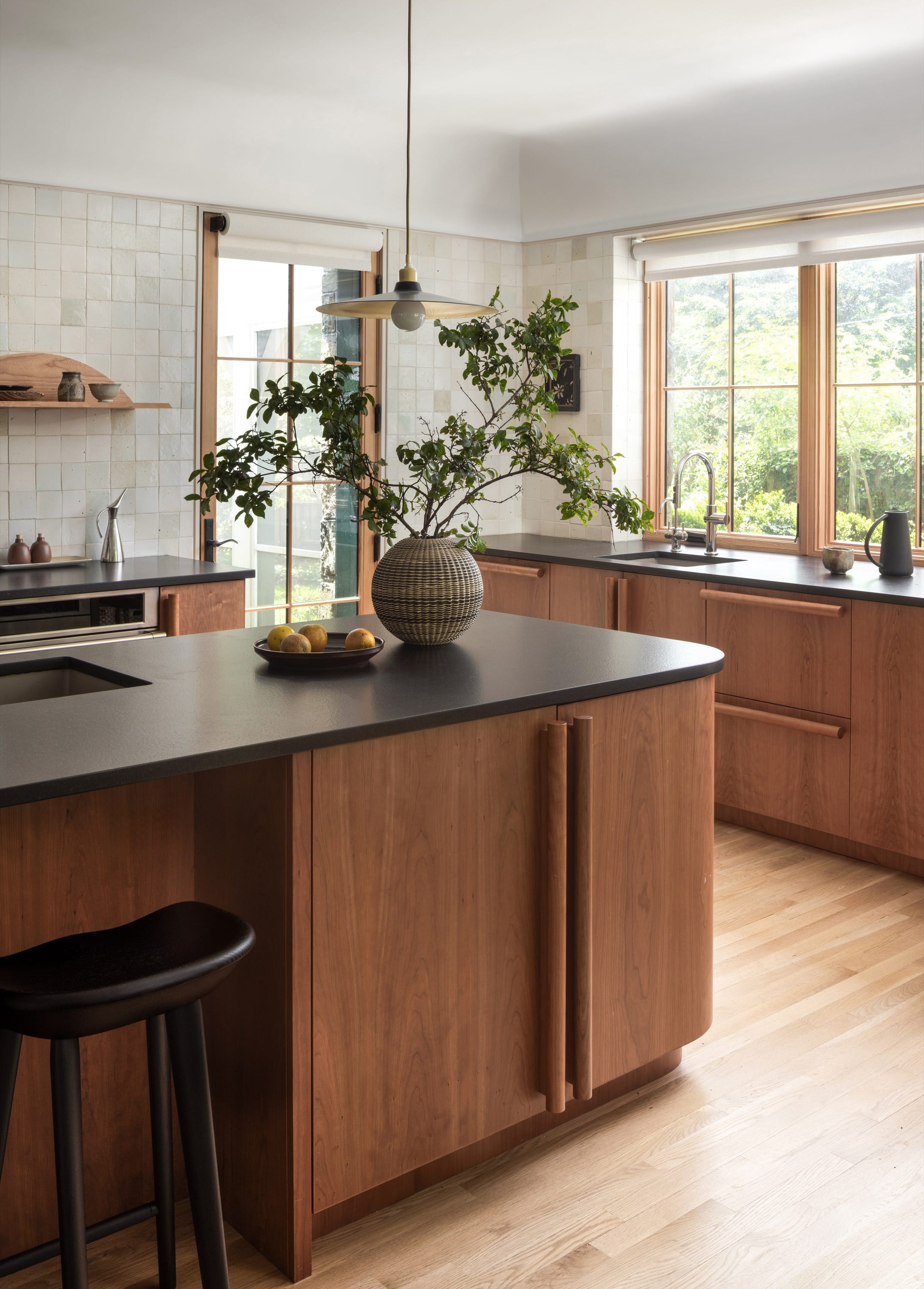 Kitchen with wood island, pendant lights, and open layout.