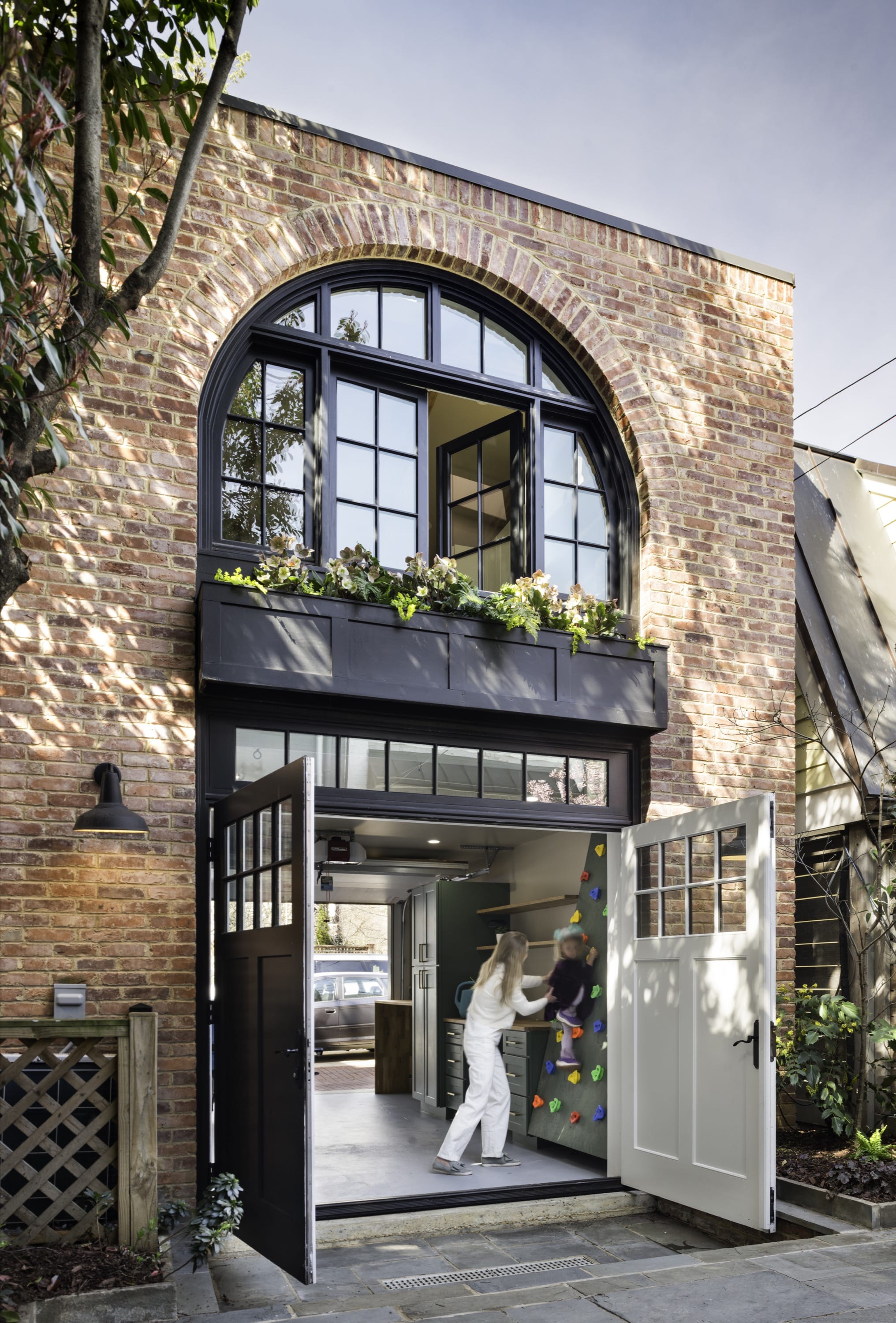 Exterior detail with arched windows and balcony planters.