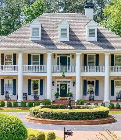 White colonial-style house with front columns

