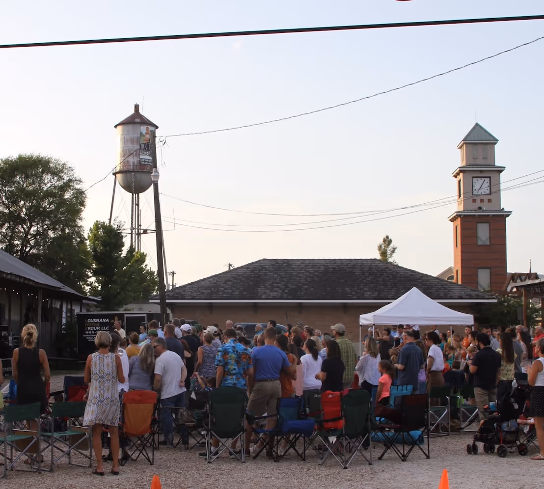 A gathering of people at an outdoor revival meeting for Awaken Northshore