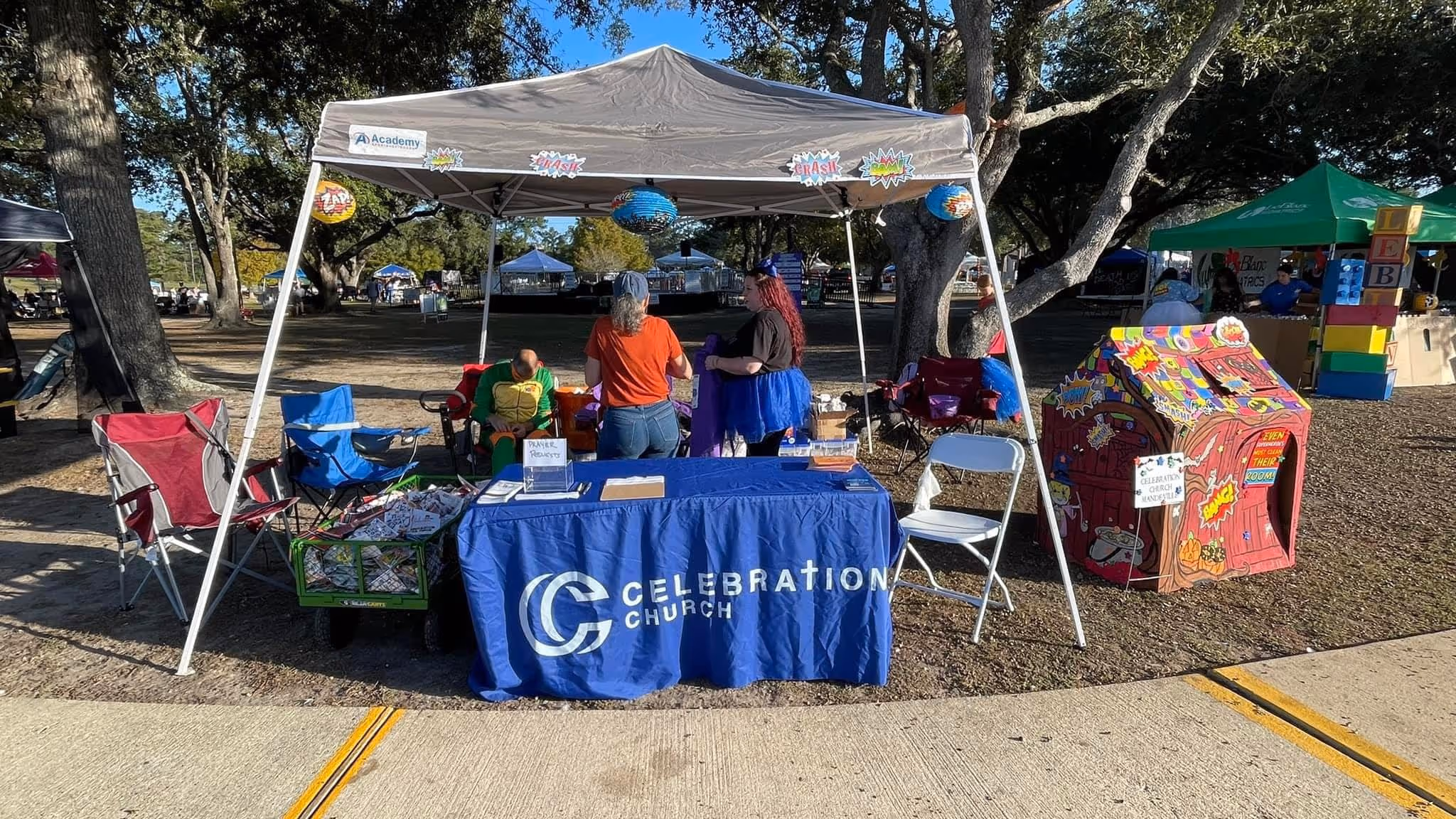 A member church of the Northshore Gospel Network (Celebration Church) hosting an outreach event with their table and tent.
