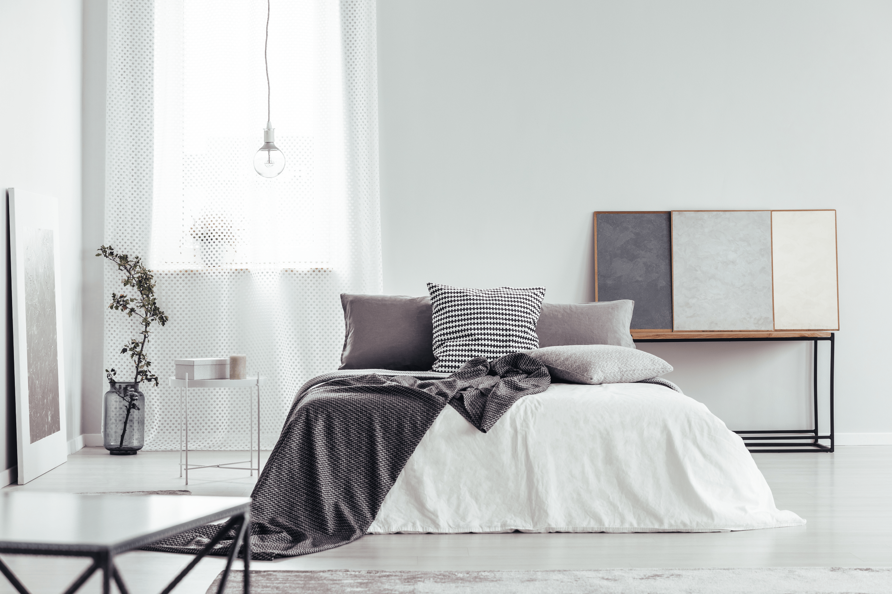 Tranquil bedroom interior with minimalist grey palette, layered soft furnishings and natural light — ideal for modern bedroom design in Leeds