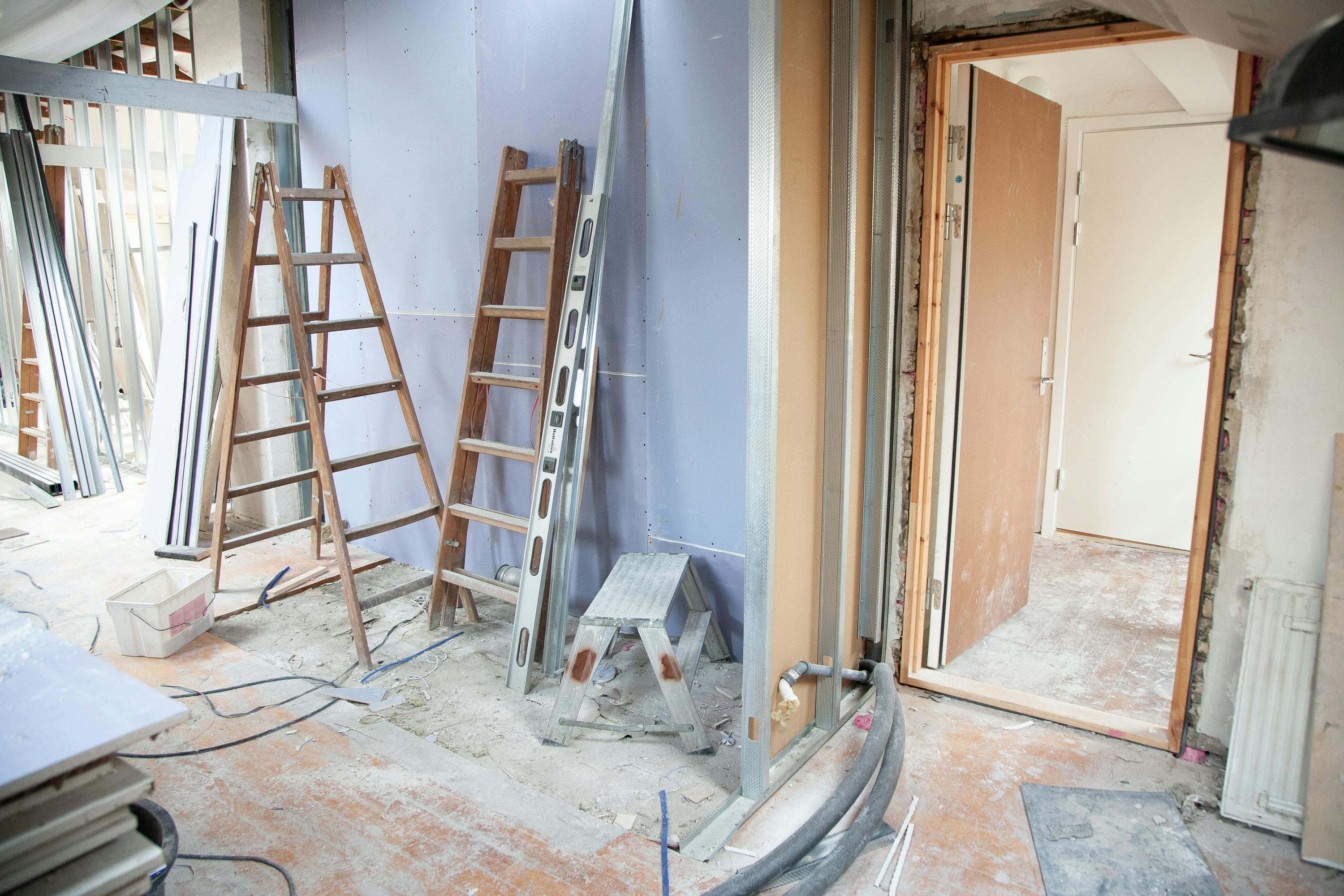 Home renovation in progress with exposed walls and tools, representing the build phase of our renovation packages.