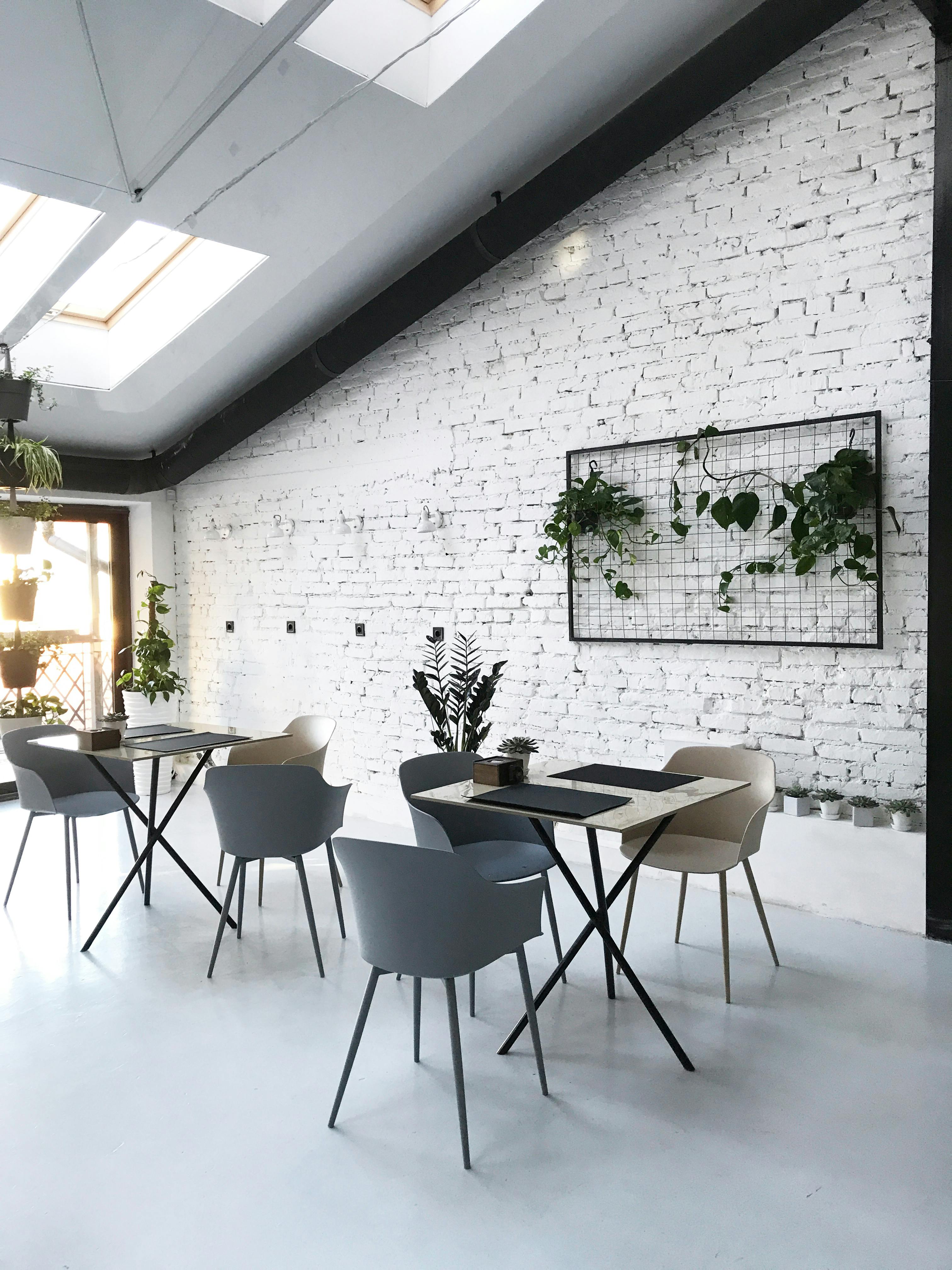 Open plan loft conversion with vaulted ceiling, Velux skylights, and modern industrial dining space. Example of a future attic renovation in Leeds.