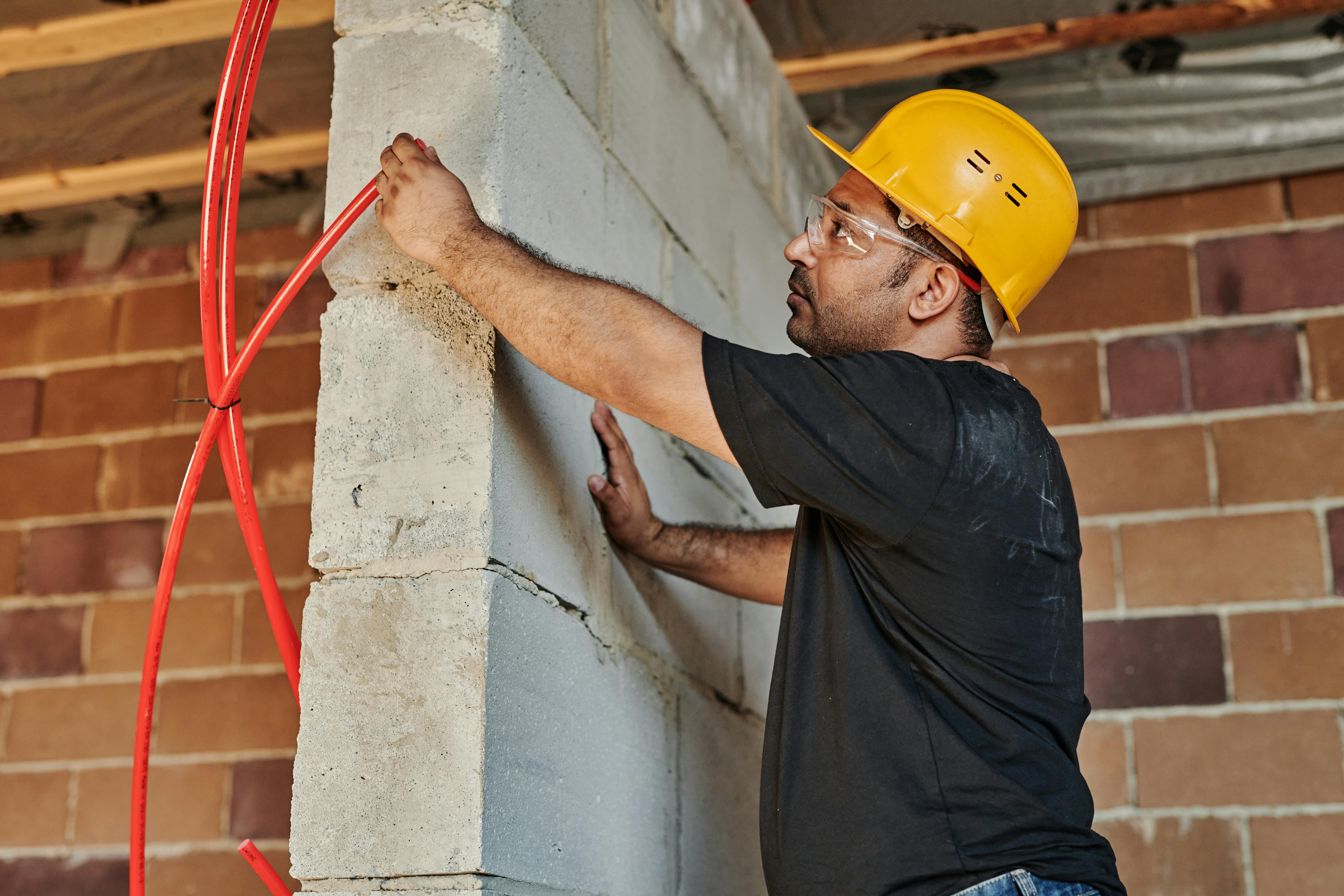 Contractor fitting insulation during a full property renovation. Example of structural work in a complete home remodel planned for clients in Bradford.