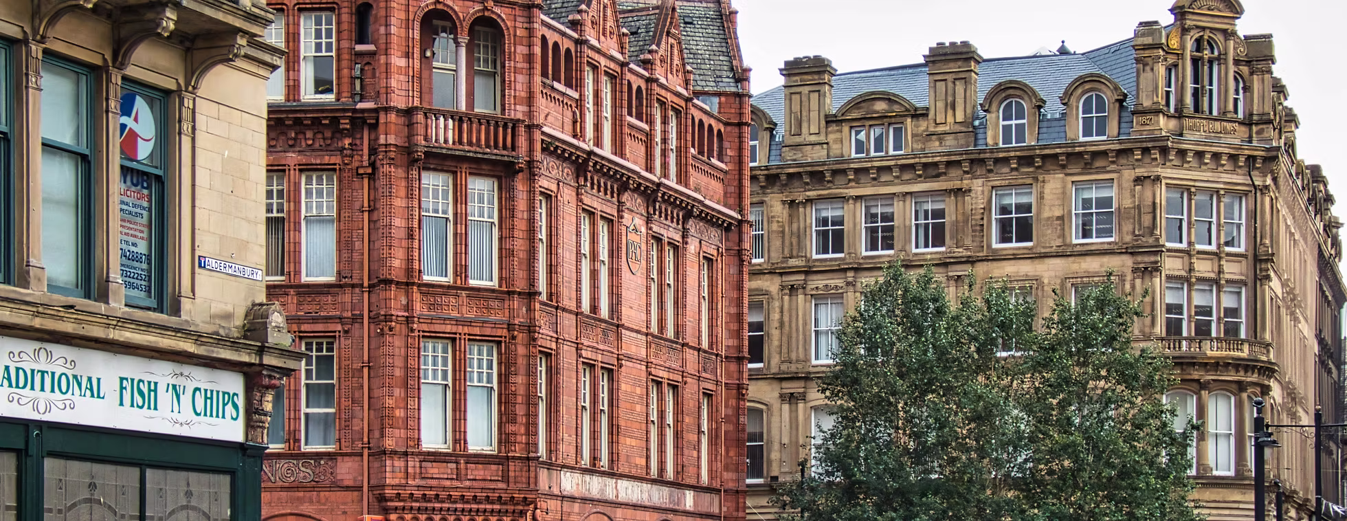 Historic red brick and sandstone buildings in central Bradford, capturing the city’s architectural character and renovation potential