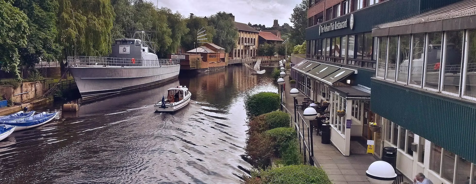 Riverside dining and boat views in York city centre, reflecting the charm and character of interior design projects in historic locations