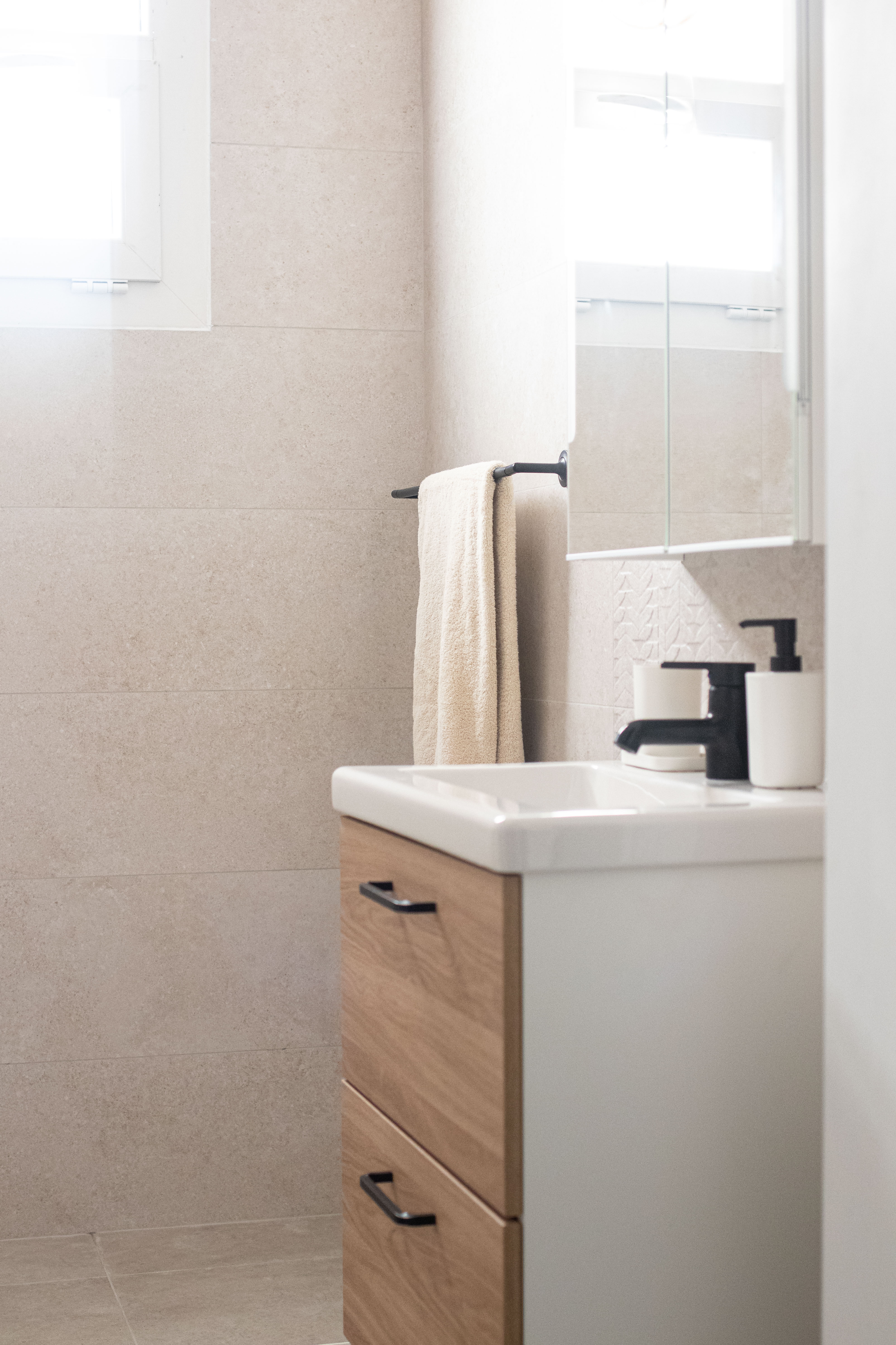 Modern compact bathroom design with oak effect vanity, matt black tap, and soft neutral tiles. Inspiration for future renovation projects in Harrogate.