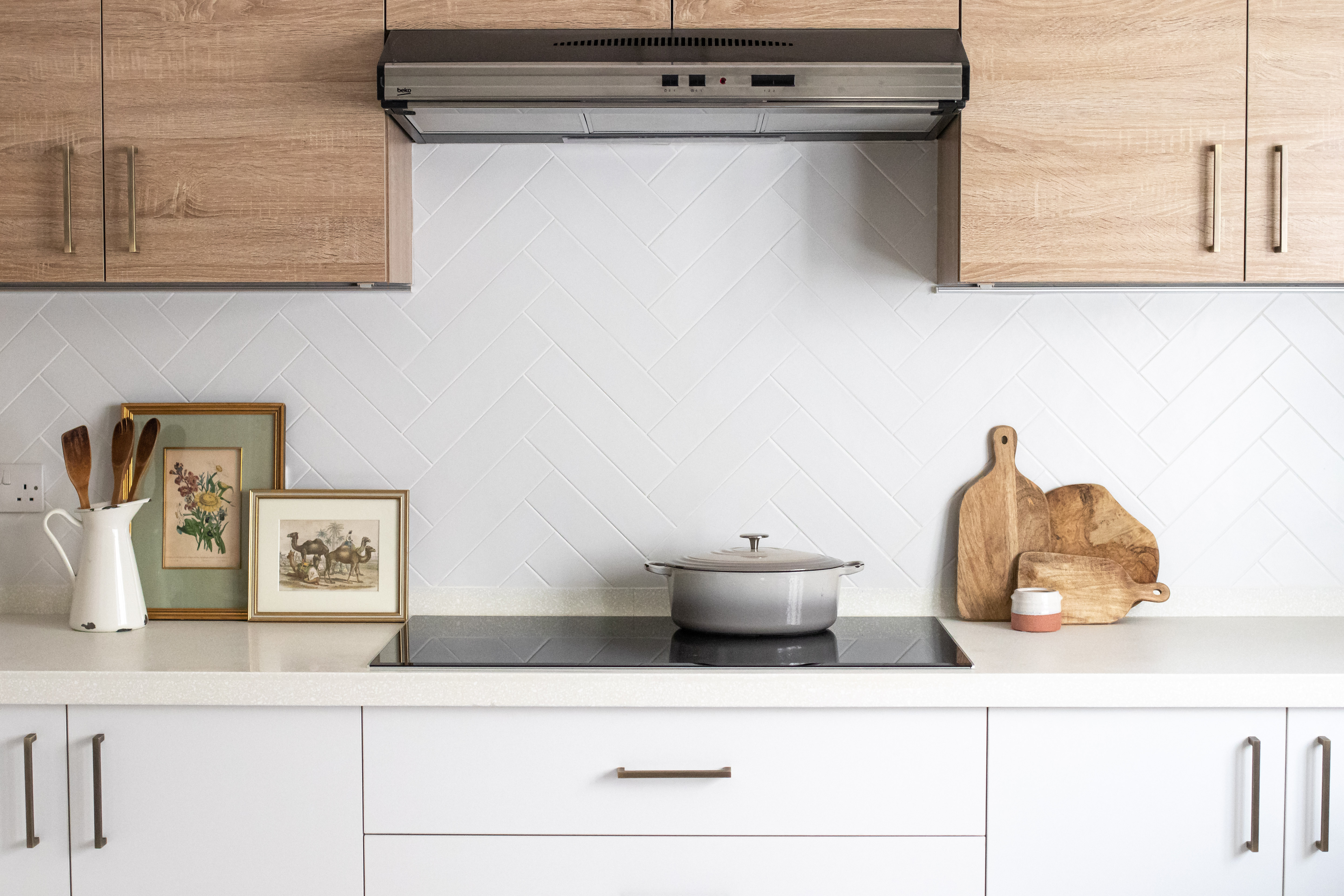 we offer bespoke kitchen interior design in Leeds featuring white cabinetry, wood accents, and a contemporary induction hob part of our home renovation services across Yorkshire
