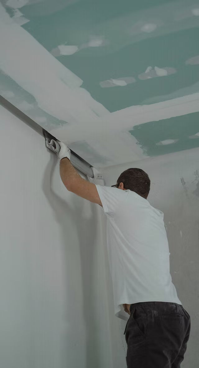 Plastering a newly built ceiling during a property renovation in Leeds. High quality finish as part of structural and cosmetic upgrades.
