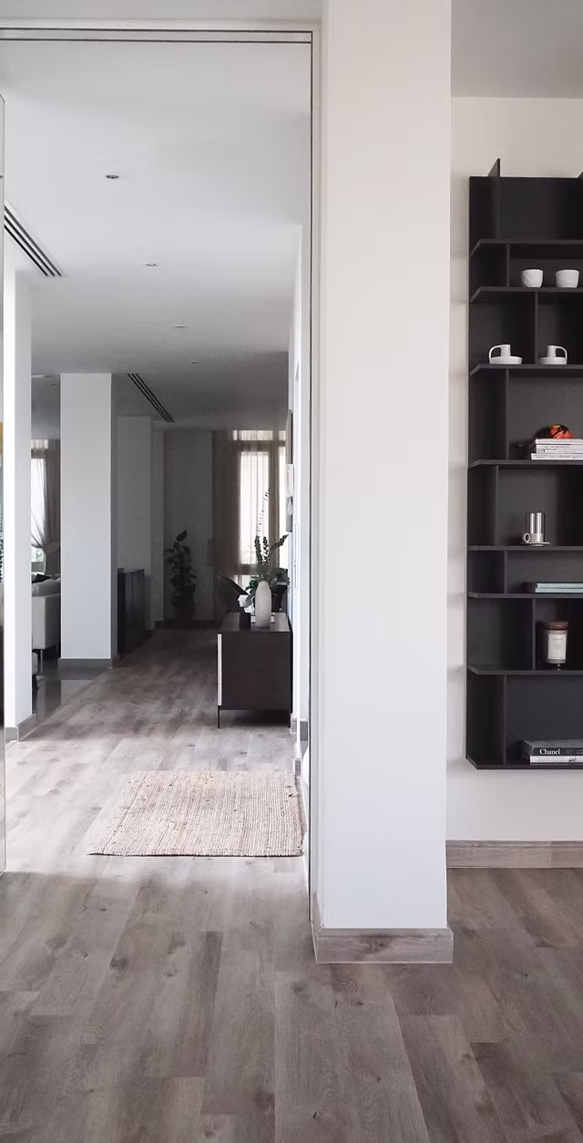 Modern open-plan home interior with natural light and wooden flooring, showcasing the results of a full home renovation package.