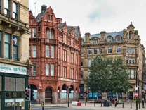 Historic red brick and sandstone buildings in central Bradford, highlighting Yorkshire’s property investment potential in 2025.