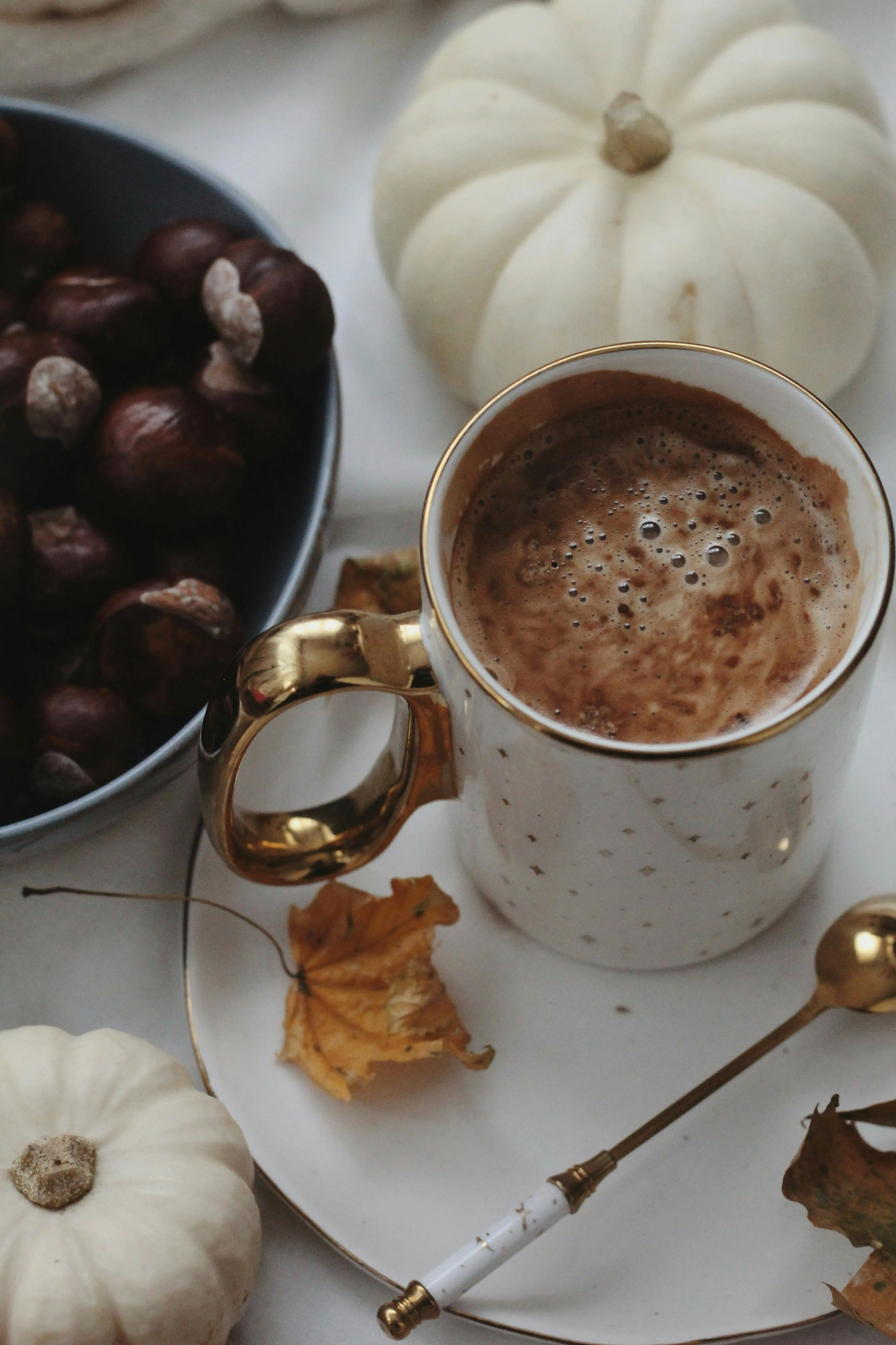 Autumn home styling with hot chocolate, white pumpkins, and chestnuts — cosy seasonal décor inspiration from Roberts Renovations, fall décor trends 2025